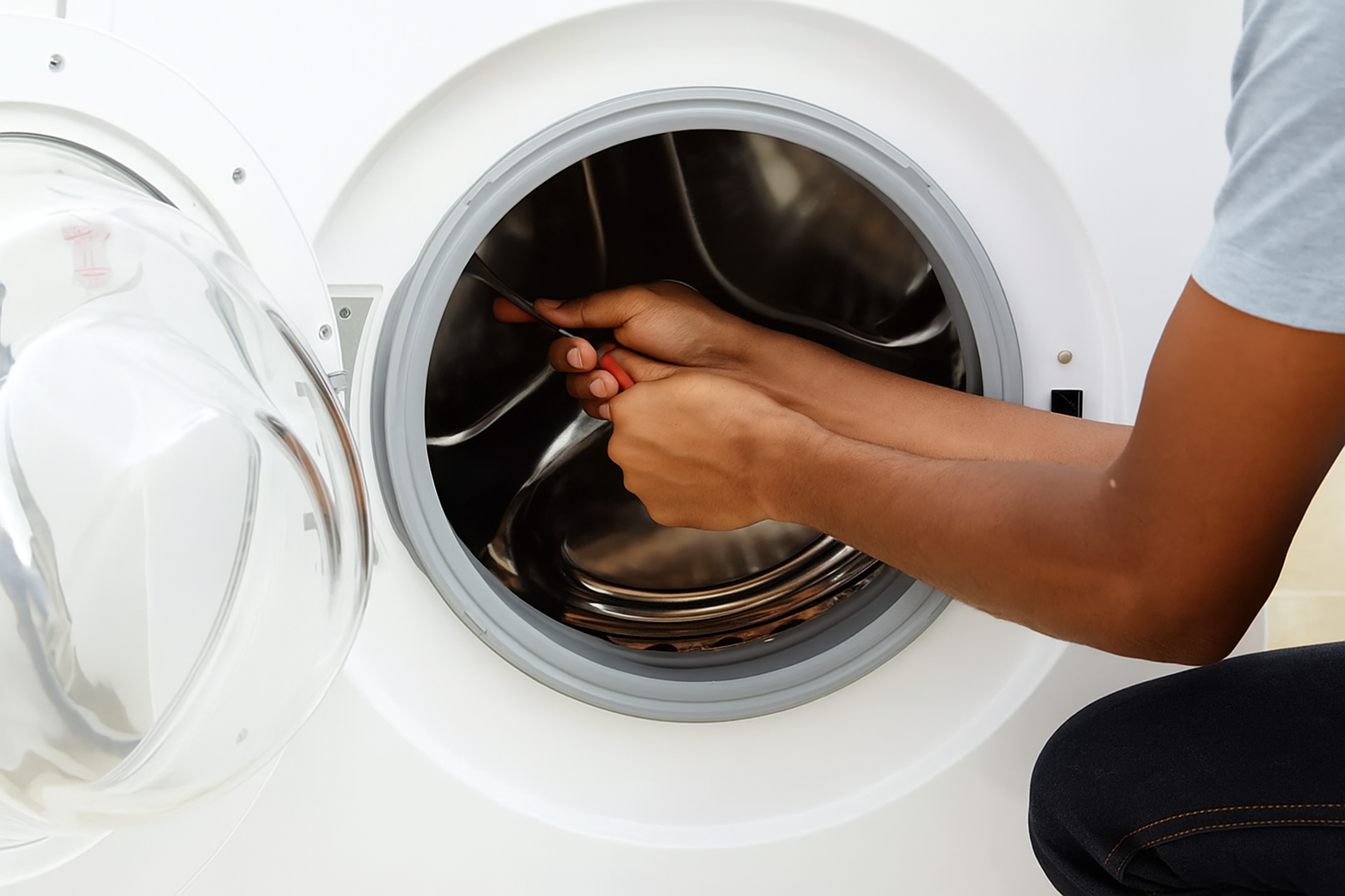 Technician repairing washing machine door seal, Appliance Repair Victoria.